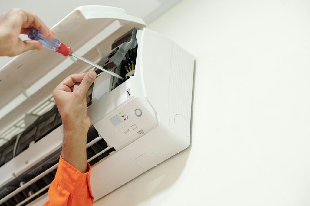 Technician Installing Air Conditioner